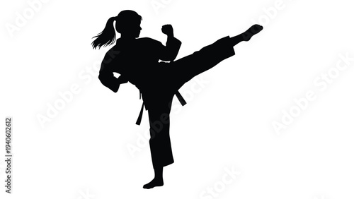 A woman in a karate uniform kicks her leg up high