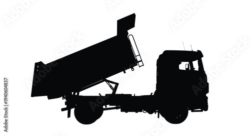 A striking silhouette of a heavy duty dump truck is presented in a stark black and white composition emphasizing its industrial form