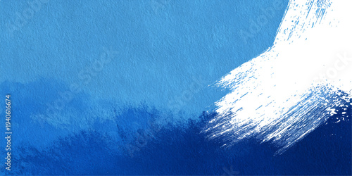 Abstract deep blue ocean waves with a clear summer sky and sunlight reflecting on the splash texture of a nature surface