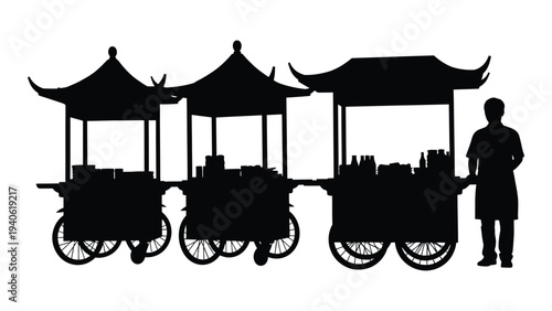 A man standing next to a row of food carts