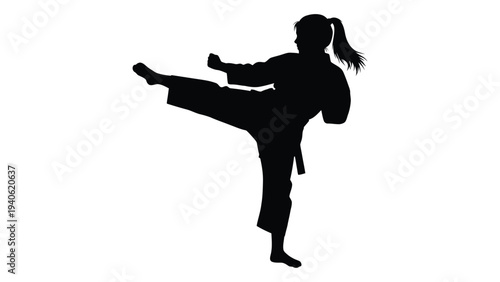 A woman in a karate uniform is kicking her leg up in the air