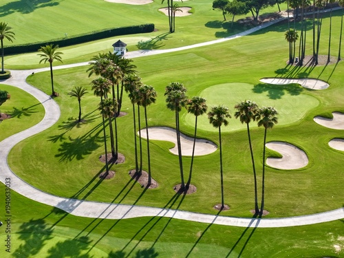 Fotografi aerial view of a luxurious golf course with high palms and fairway bunkers in be
