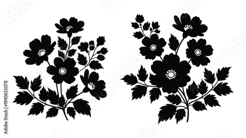 A pair of black floral arrangements with leaves