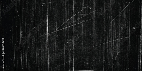 Abstract black and white texture with vertical and diagonal scratches resembling old film grain