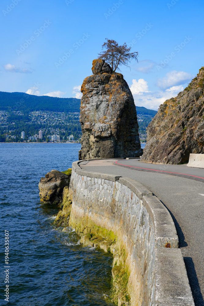 Fototapeta premium Siwash rock, a monolith in the waters of Burrard Inlet on the west coast of Stanley Park in Vancouver, British Columbia, Canada