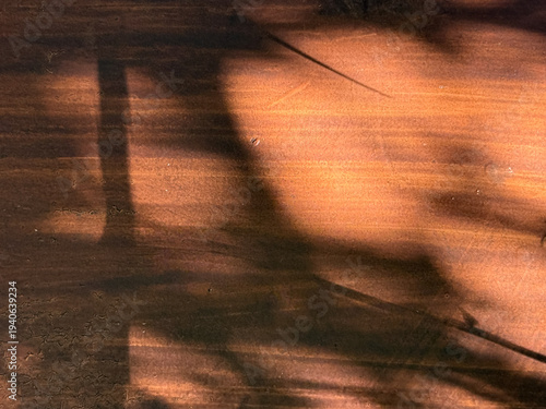 A wooden table with a chair in the foreground