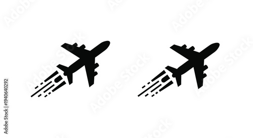 Two airplanes in flight with contrails a striking black silhouette