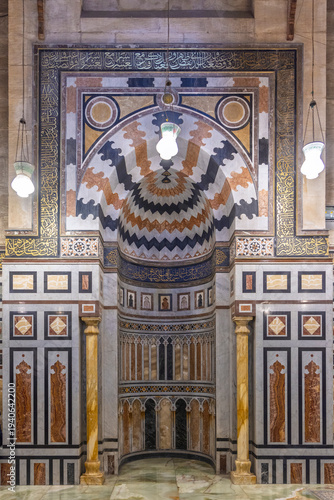 Ornate Islamic mihrab and mosque interior with marble inlay in Cairo, Egypt, traditional architecture