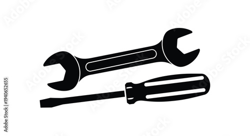 Black and white illustration of a wrench and a flathead screwdriver