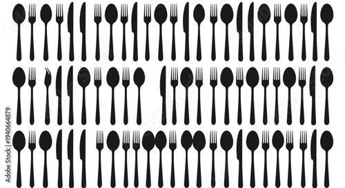 A collection of black silverware including forks knives and spoons