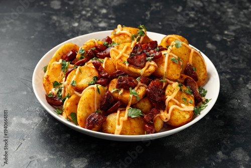 Patatas bravas with chorizo and sauce. Spanish traditional food