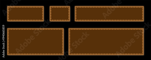 Various sizes of orange marquee frames with brilliant glowing bulbs stand out on black