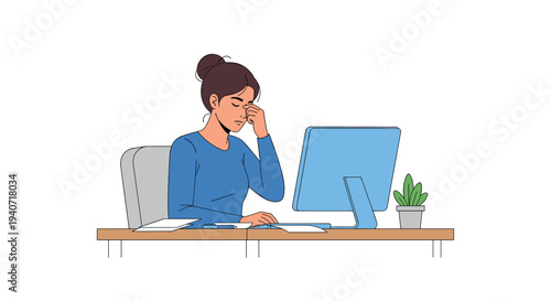 A stressed woman in a blue shirt holds her hand to her eyes while sitting at a desk with a computer and plant.