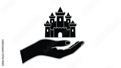 A hand gently holds a castle in a dramatic silhouette