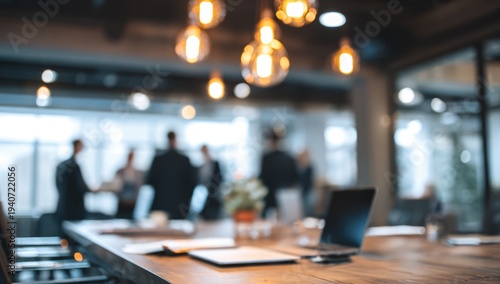 Blurred office interior with people and warm lighting.