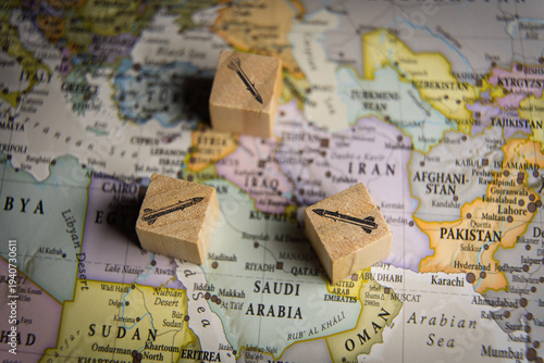 Wooden cubes with missile icons placed on a geographic map of the Middle East, symbolizing regional conflict, military tension, and geopolitical war risk in Iran, Israel, USA, and Saudi Arabia
