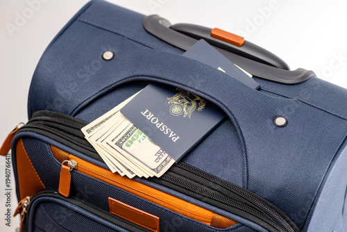 American passport and money in suitcase pocket preparing for international travel
