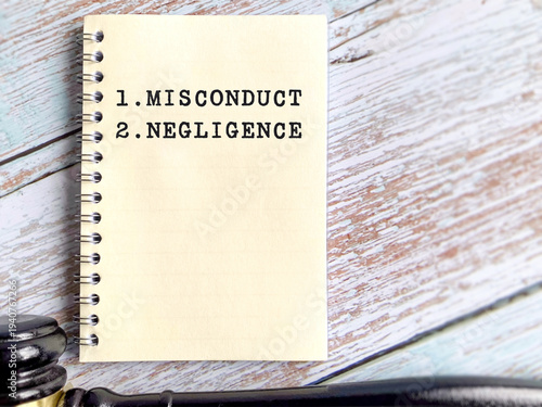 Photos Note book displaying misconduct and negligence terms representing workplace violation, legal responsibility, corporate ethics and employee discipline concept