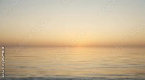 Soft golden sunrise over calm, rippling water