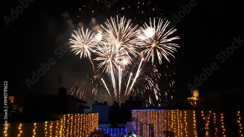 Wallpaper Mural Spectacular Fireworks Display Illuminates the Night Sky Over Decorated Buildings. Torontodigital.ca