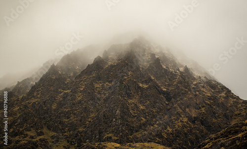 grey mountain wall and mist