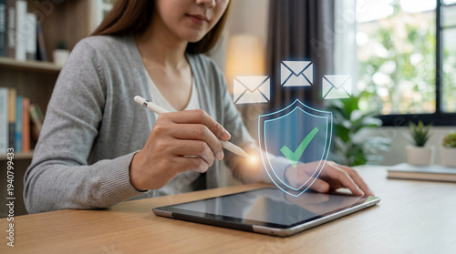Woman using tablet with secure vpn shield and email protection icons