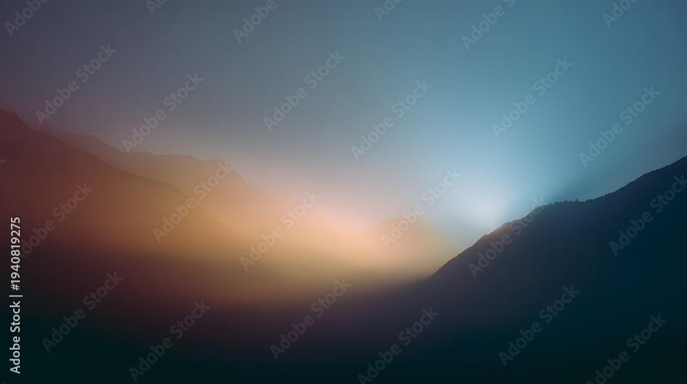 Obraz premium Dramatic Sunset Over Mountain Range with Hazy Sky.