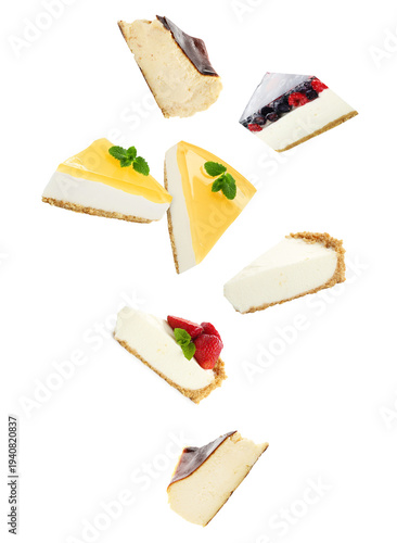 Pieces of different yummy cheesecakes falling on white background