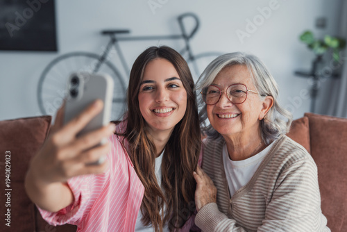 Cuadro en lienzo Head shot portrait happy woman with mature mother taking selfie on smartphone to