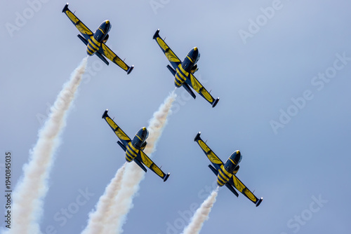 Four L-39 Albatros jets flying in formation with smoke trails.