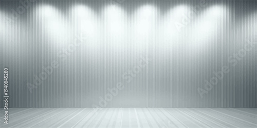An empty white room interior features a brushed silver metal wall texture and a stainless steel floor plate illuminated by bright spotlights on a grey metallic backdrop space
