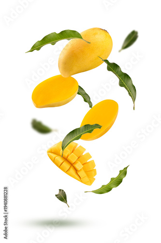 Floating Ripe Yellow Mango Slices with Flying Green Leaves on white background. summer drinks, healthy desserts, and food .