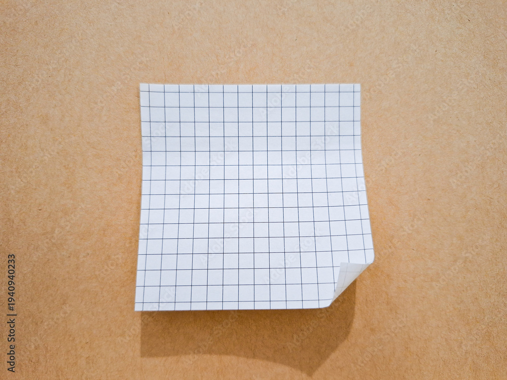 Fototapeta premium white grid sticky note paper on a brown paper background
