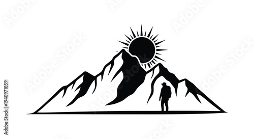 Silhouette of a hiker stands before a mountain range and rising sun