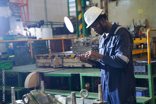 Professional quality control engineer inspecting precision automotive metal parts in a manufacturing factory.