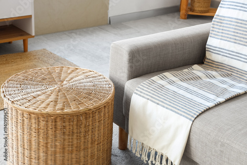 Wicker table near sofa in l...
