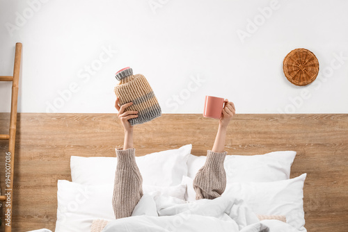 Young woman with hot water ...