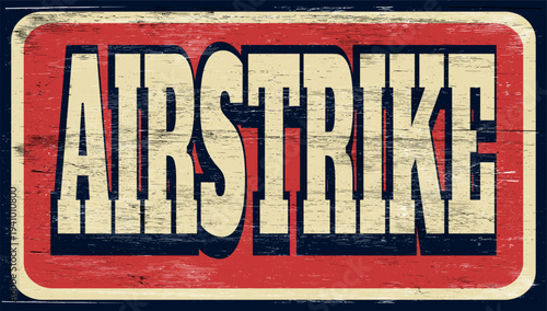 Aged and worn airstrike sign on wood