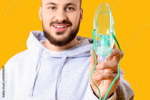 Young man with nebulizer on...