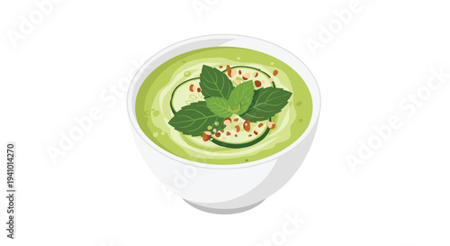 An isometric view of a white bowl filled with green soup garnished with cucumber slices mint leaves and chopped nuts.