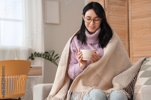 Young woman with warm plaid...