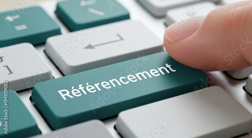 Finger Pressing Teal Référencement Button on Keyboard for French Search Engine Optimization Concept