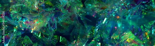 Abstract dark green black blue foil texture background banner. Crumpled iridescent hologram blured festive backdrop.