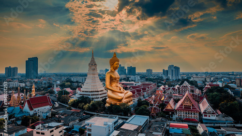 Quadro em tela Spectacular aerial view of the giant golden Buddha statue and stupa at Wat Paknam Bhasicharoen with dramatic sky and sunbeams in Bangkok, Thailand