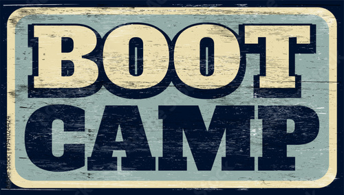 Aged and worn boot camp sign on wood