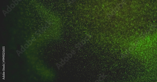 Defocused particles. Green light leak. Glimmer bright color glitter optical bokeh gleam vibrant twinkle on abstract art background.