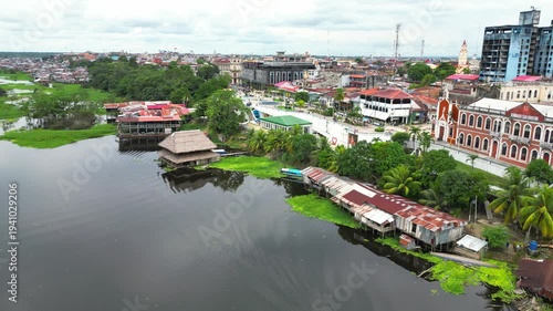 High-resolution aerial view of the riverfront boulevard in Iquitos featuring colorful historic buildings, vibrant urban streets, and a scenic promenade along the majestic Amazon River