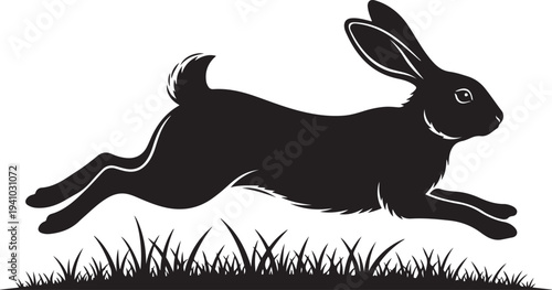 Black silhouette of a rabbit jumping over grass