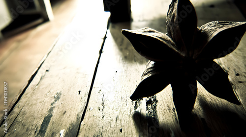 Beautiful flower on rustic wooden table with warm sunlight