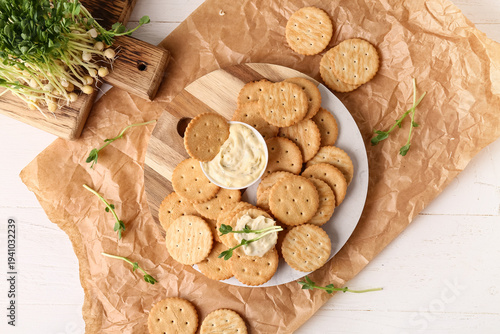 Tasty crackers with bowl of...